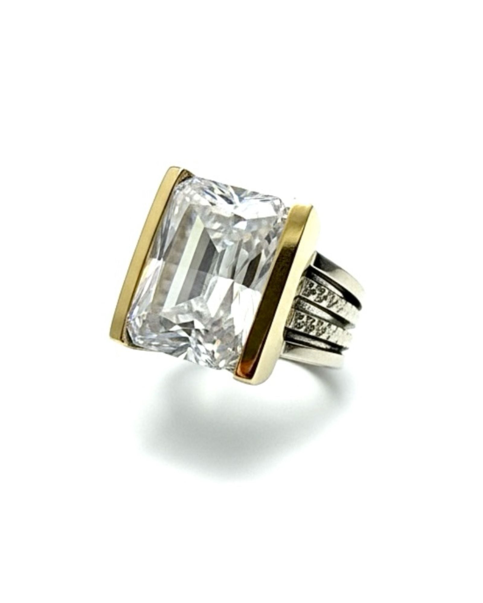 Silver and gold ring with a central stone.