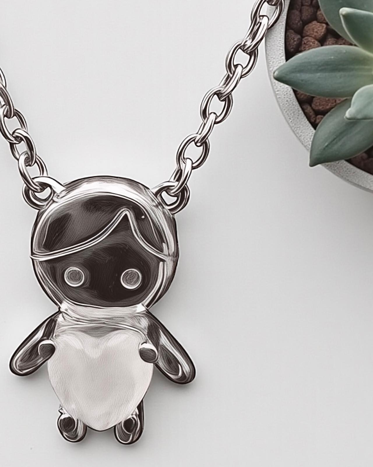 Silver necklace with boy charm and white heart.